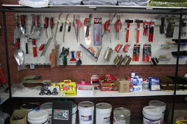 Garden tools on the wall and tins of paint