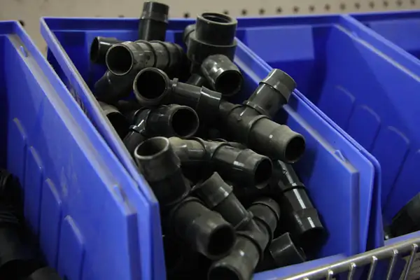 Bins of black pipe fittings