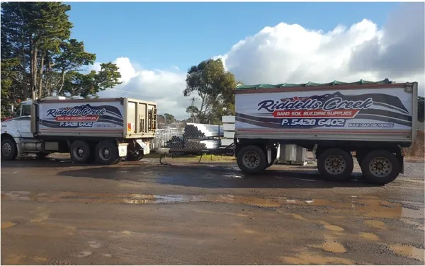 A Riddells Creek truck and dog trailer in the navy and red livery